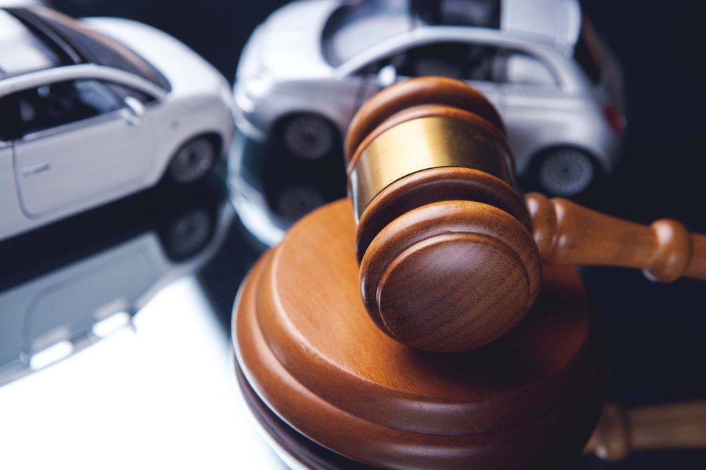 Model of car and gavel. Accident lawsuit or insurance, court cas
