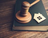Judge auction and real estate concept. House model, gavel and law books