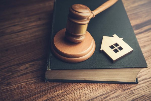 Judge auction and real estate concept Judge auction and real estate concept. House model, gavel and law books